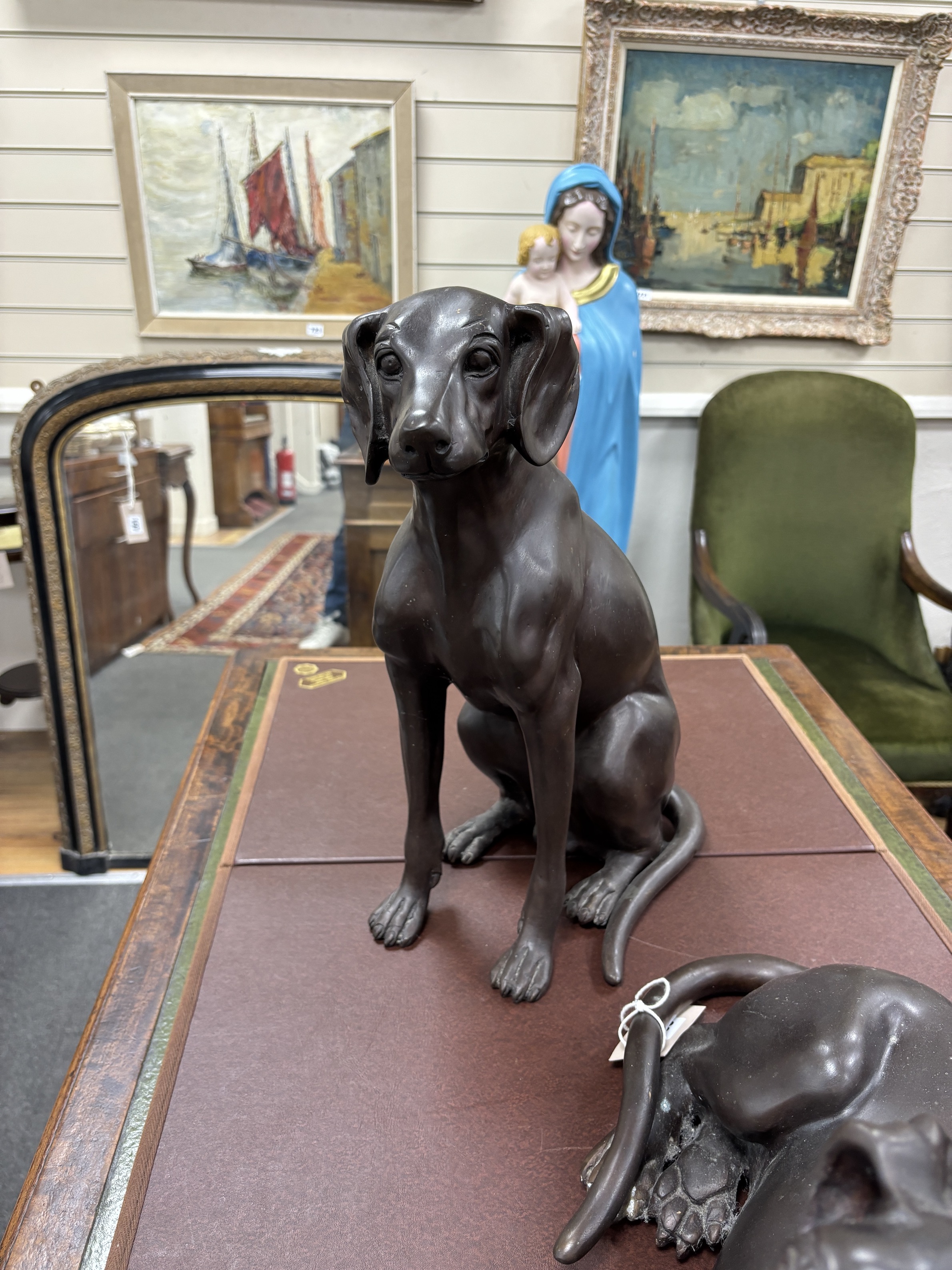 Two large bronze models of seated dogs, largest 57cm wide